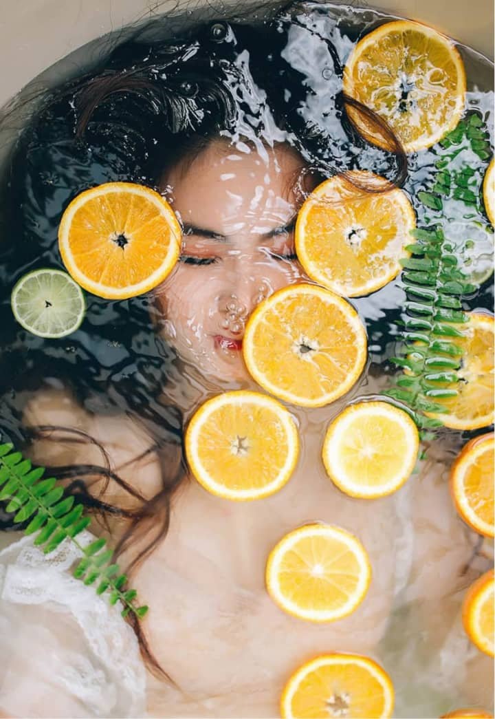 Woman Laying in Bath with Orange Slices Woman Laying in Bath with Orange Slices